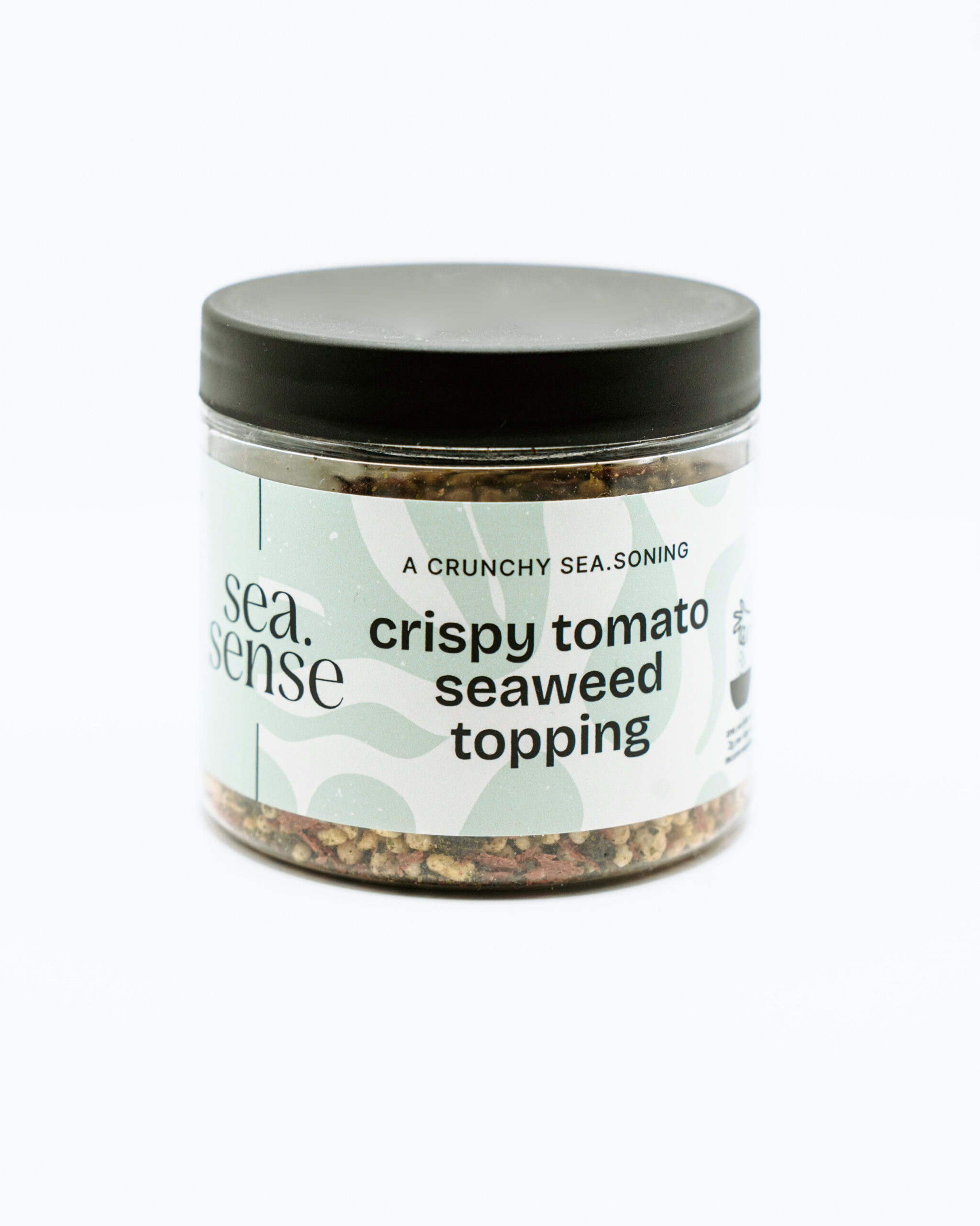 Barattolo da 75 g di Topping Sea.Sense alle Alghe e Pomodoro con etichetta verde chiaro e tappo nero, contenente mix croccante di alghe e pomodoro essiccato.