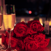 Tavola apparecchiata per una cena romantica con calici di bollicine, rose rosse e candele accese.