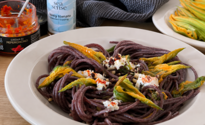 Piatto di spaghetti ai fiori di zucca con caprino, Crema di Peperoncino e Topping Sea.Sense al Pomodoro.